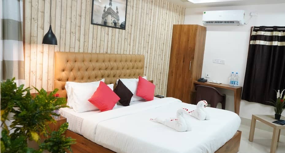 A luxurious hotel building with modern architecture and lush greenery surrounding it